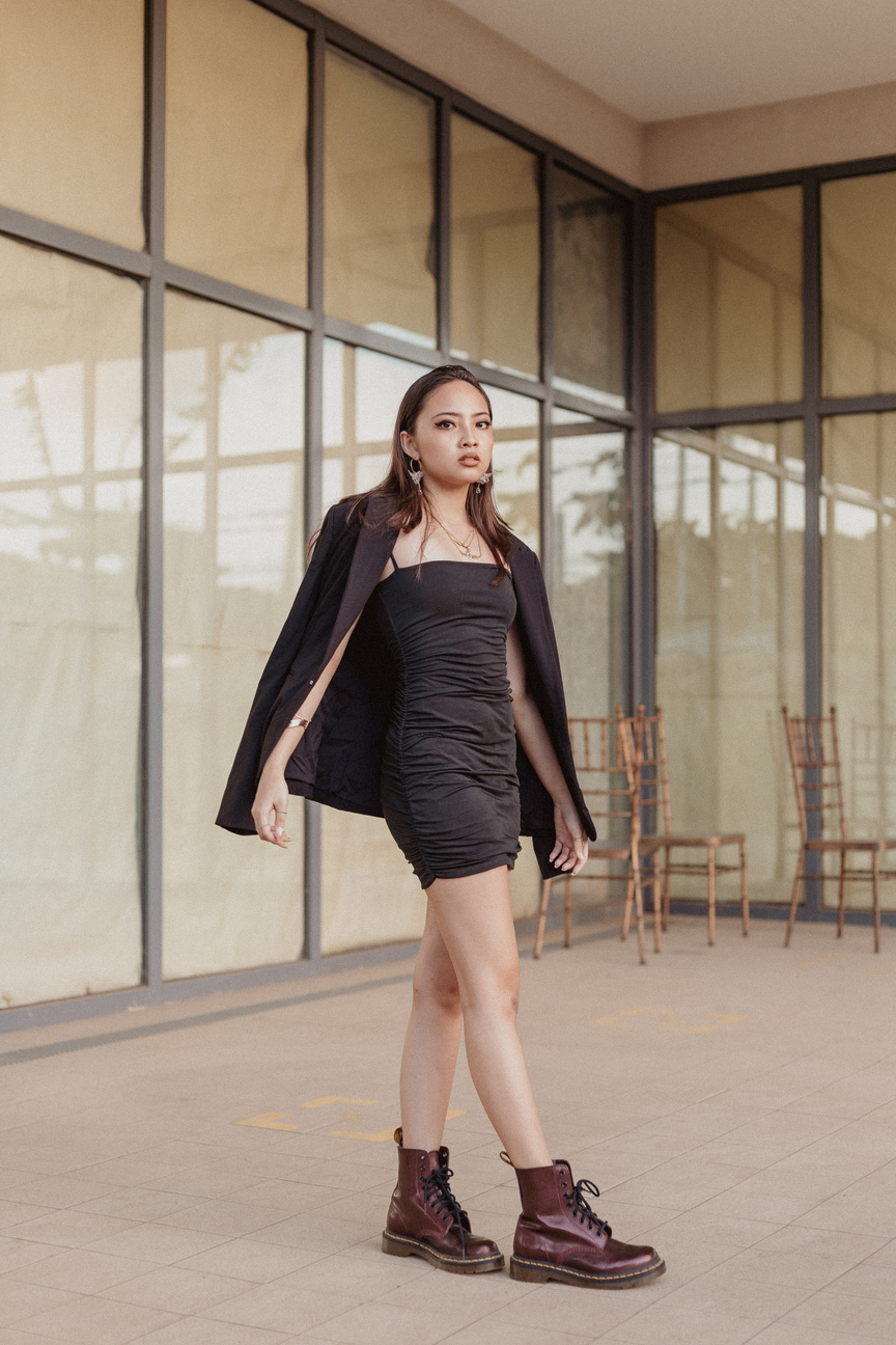 Woman in Black Dress and Coat Outdoors